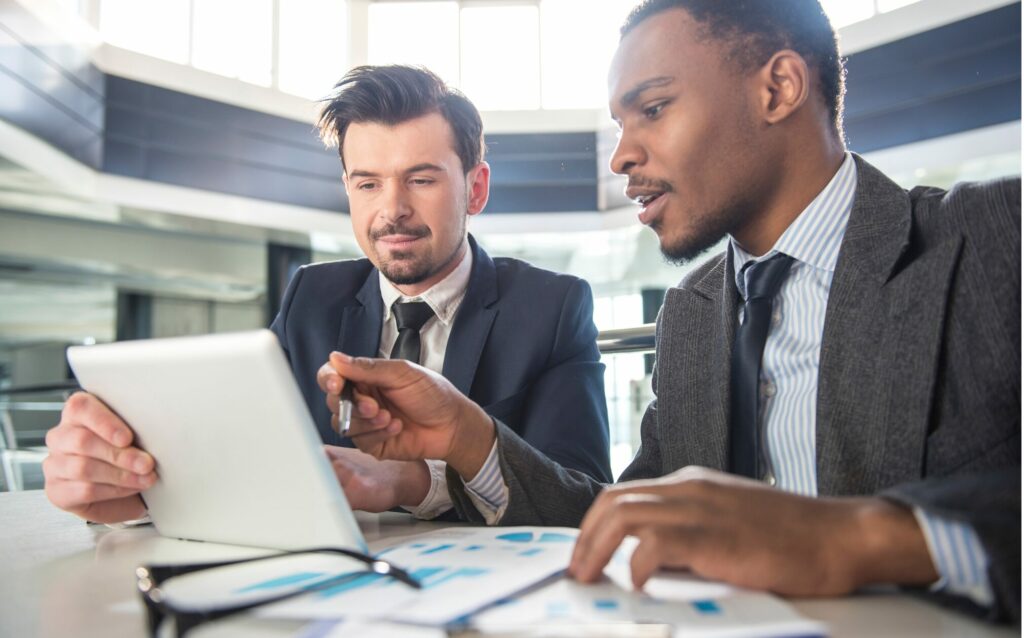 Two people in business talking about hiring a collections agency.