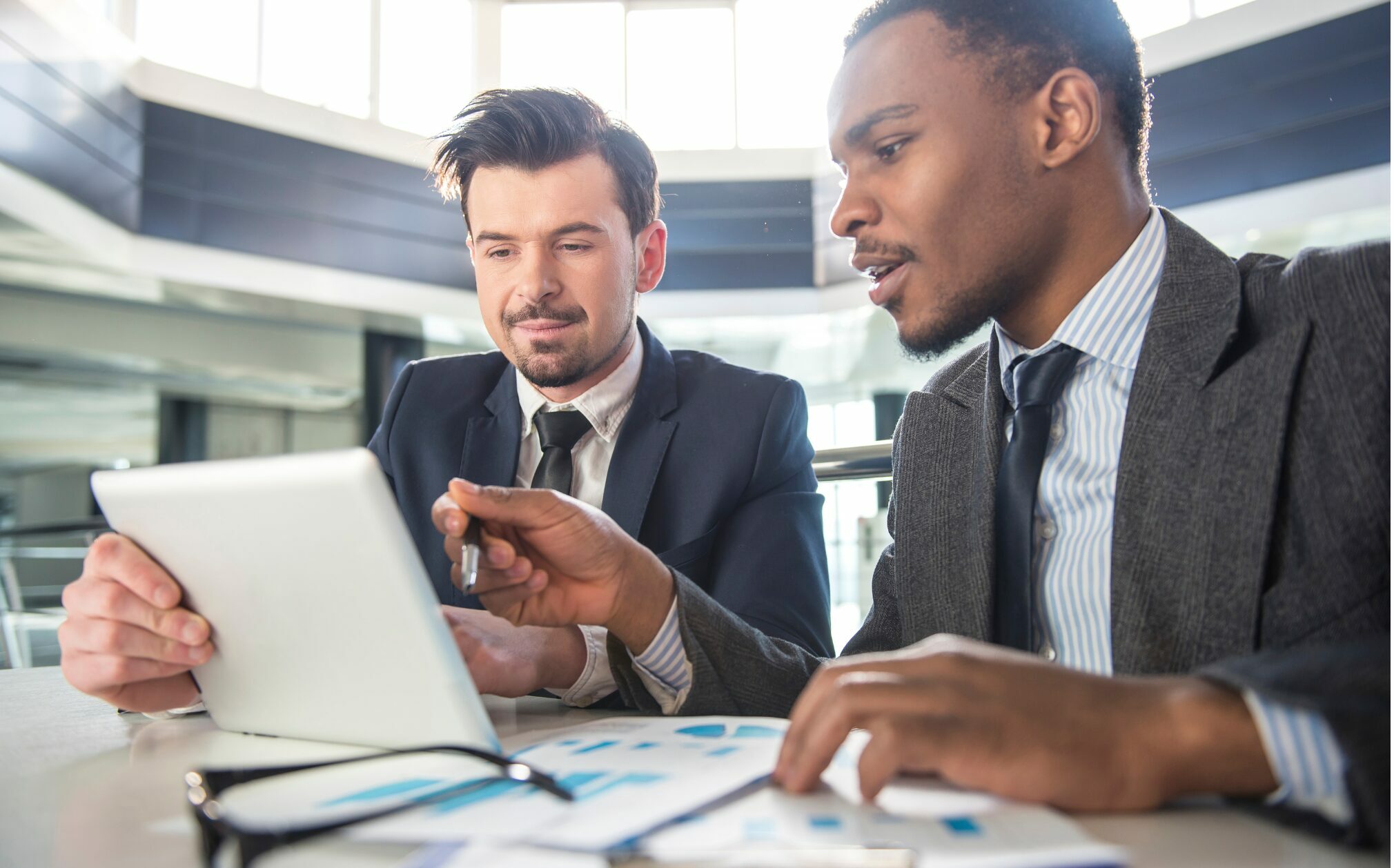 Two people in business talking about hiring a collections agency.